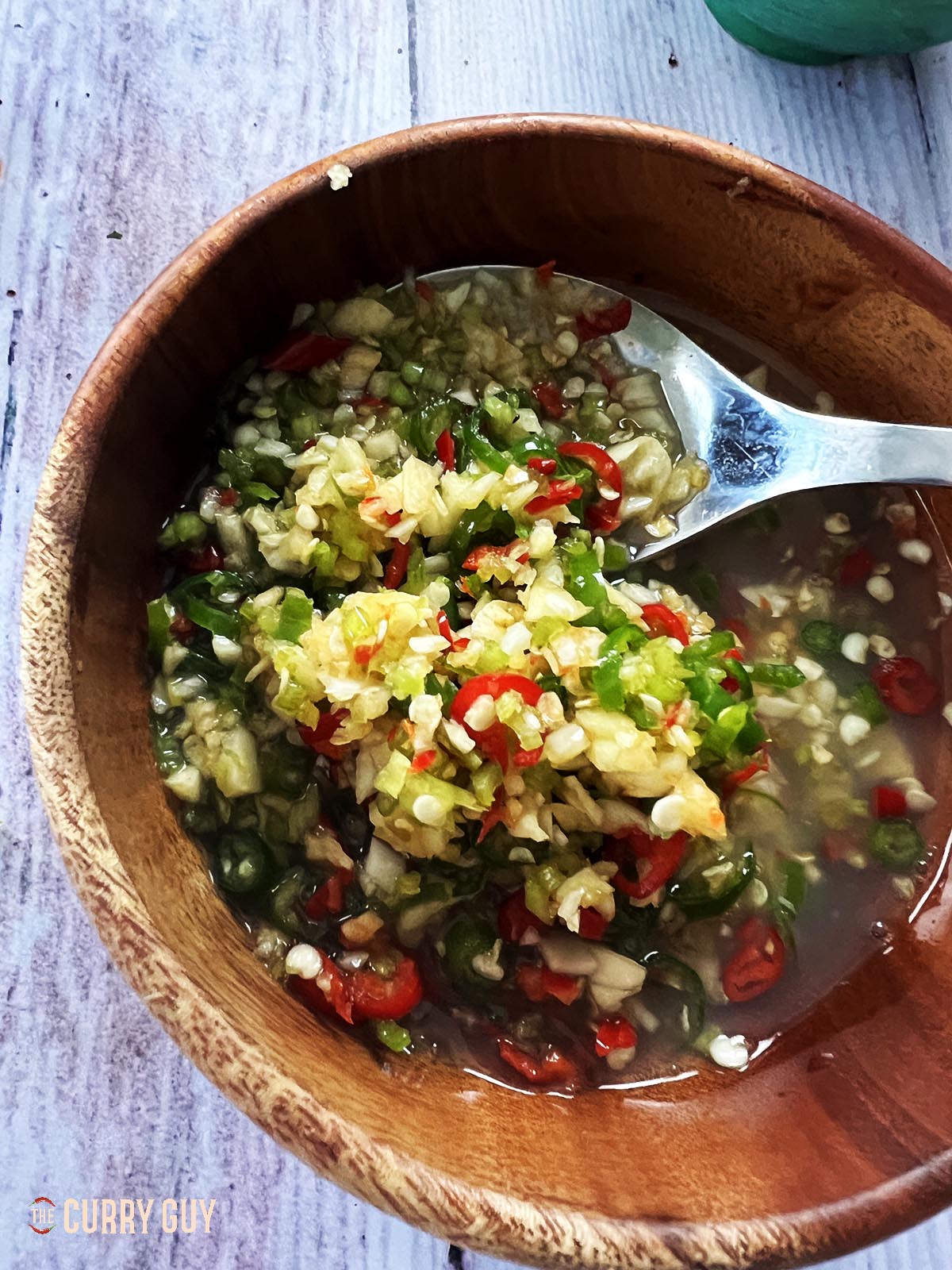 All of the prik nam pla ingredients in a serving bowl