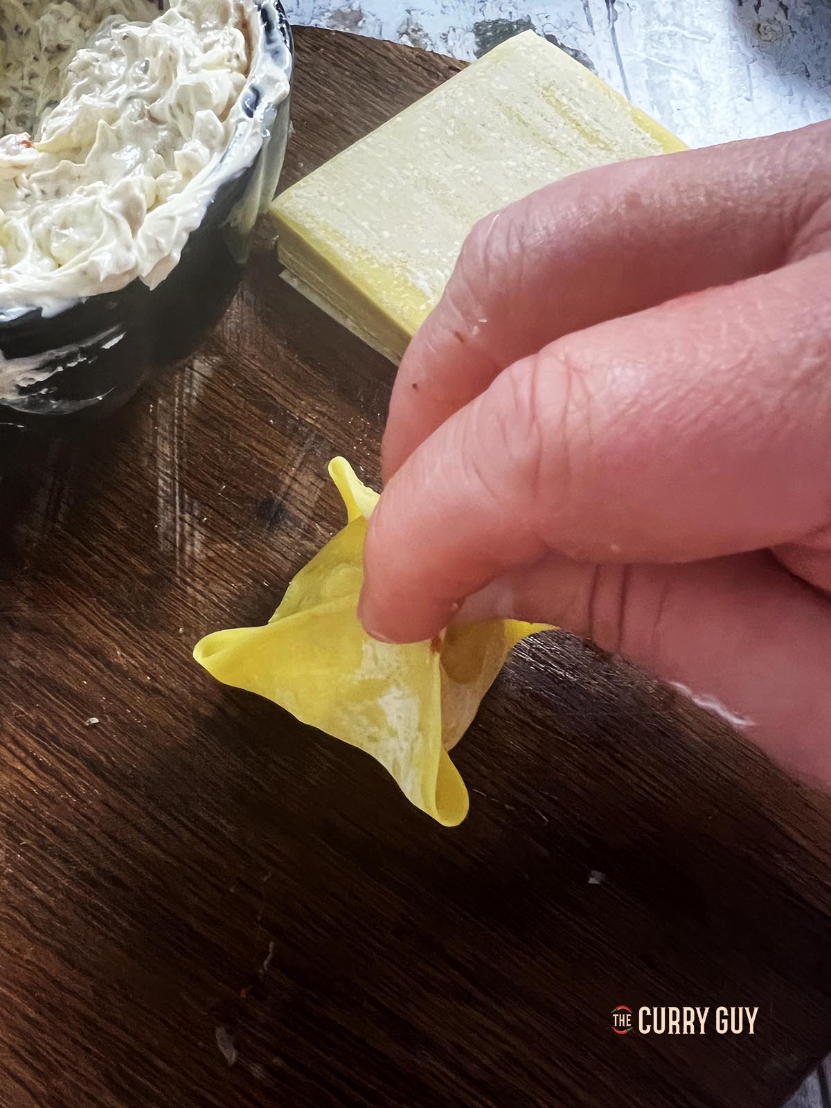 Wrapping and sealing the wonton wrapper around the filling.