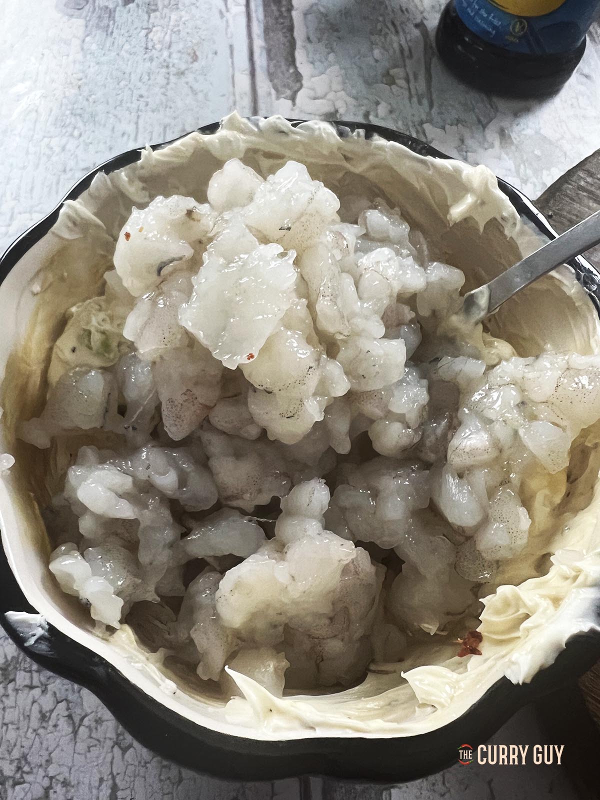 Preparing the shrimp filling in a mixing bowl.