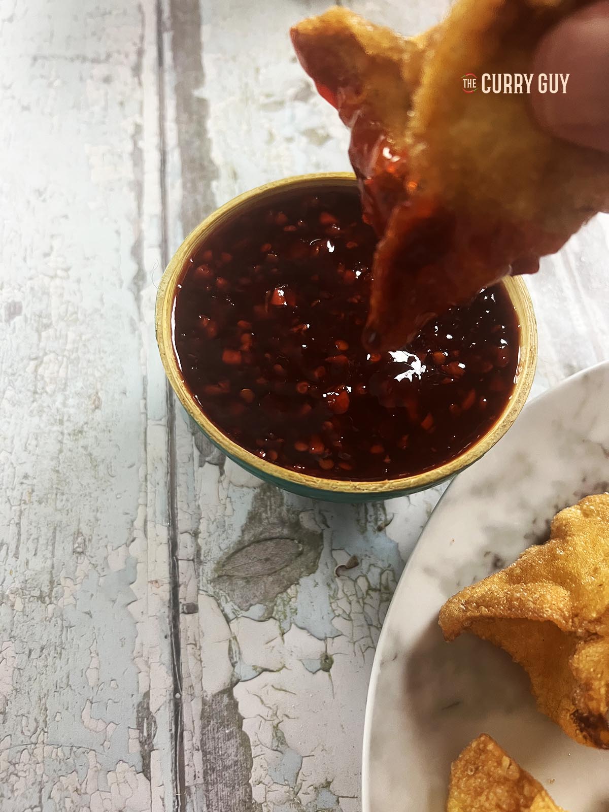 Dipping a shrimp rangoon in sweet chili sauce.