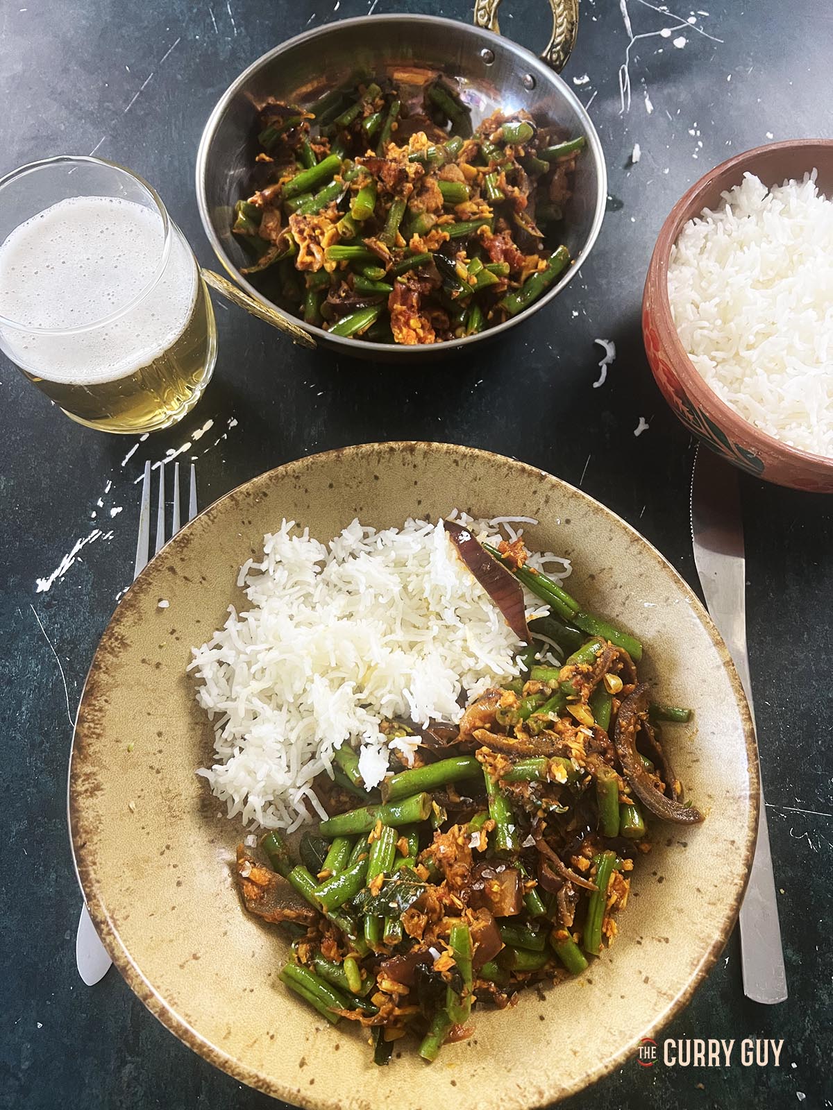 The green beans curry south Indian style served on a plate with basmati rice.