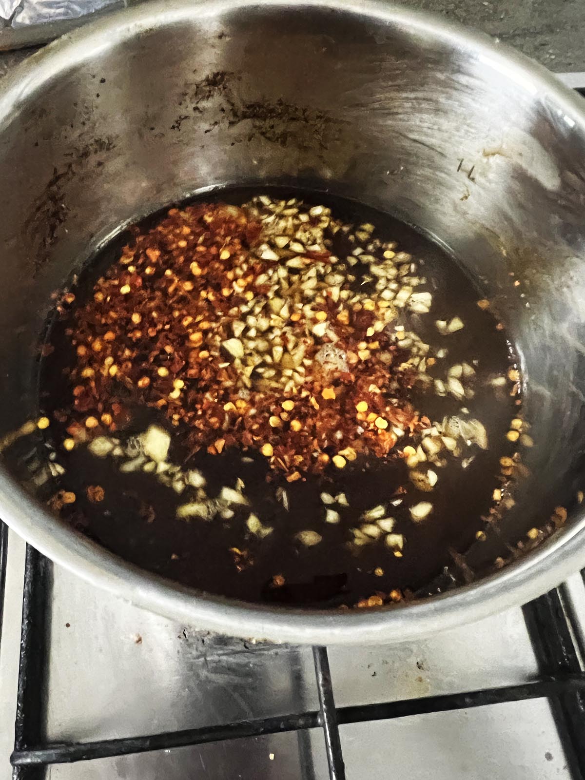 Adding the garlic, soy sauce and chili flakes to the sauce.