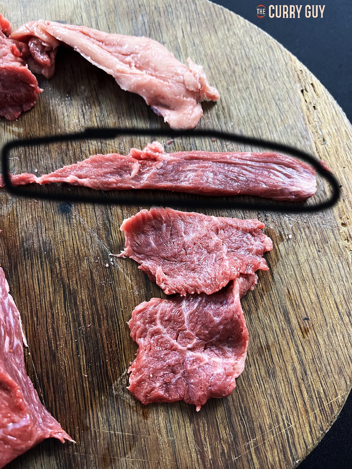 A piece of meat cut with the grain of the meat.