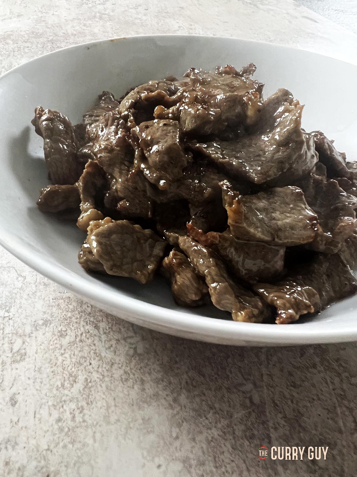 The par-cooked velveted beef.