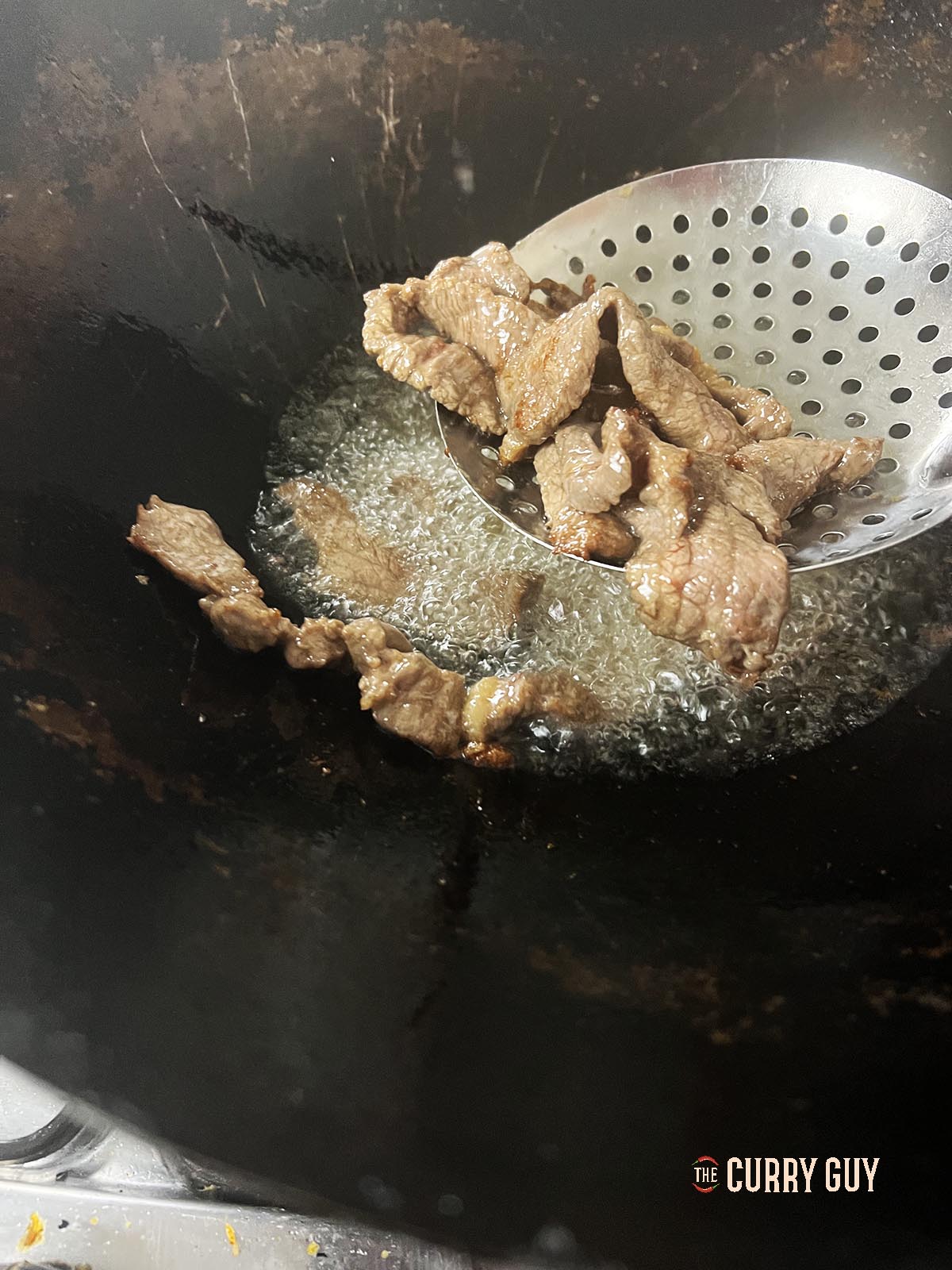 Flash frying the beef.