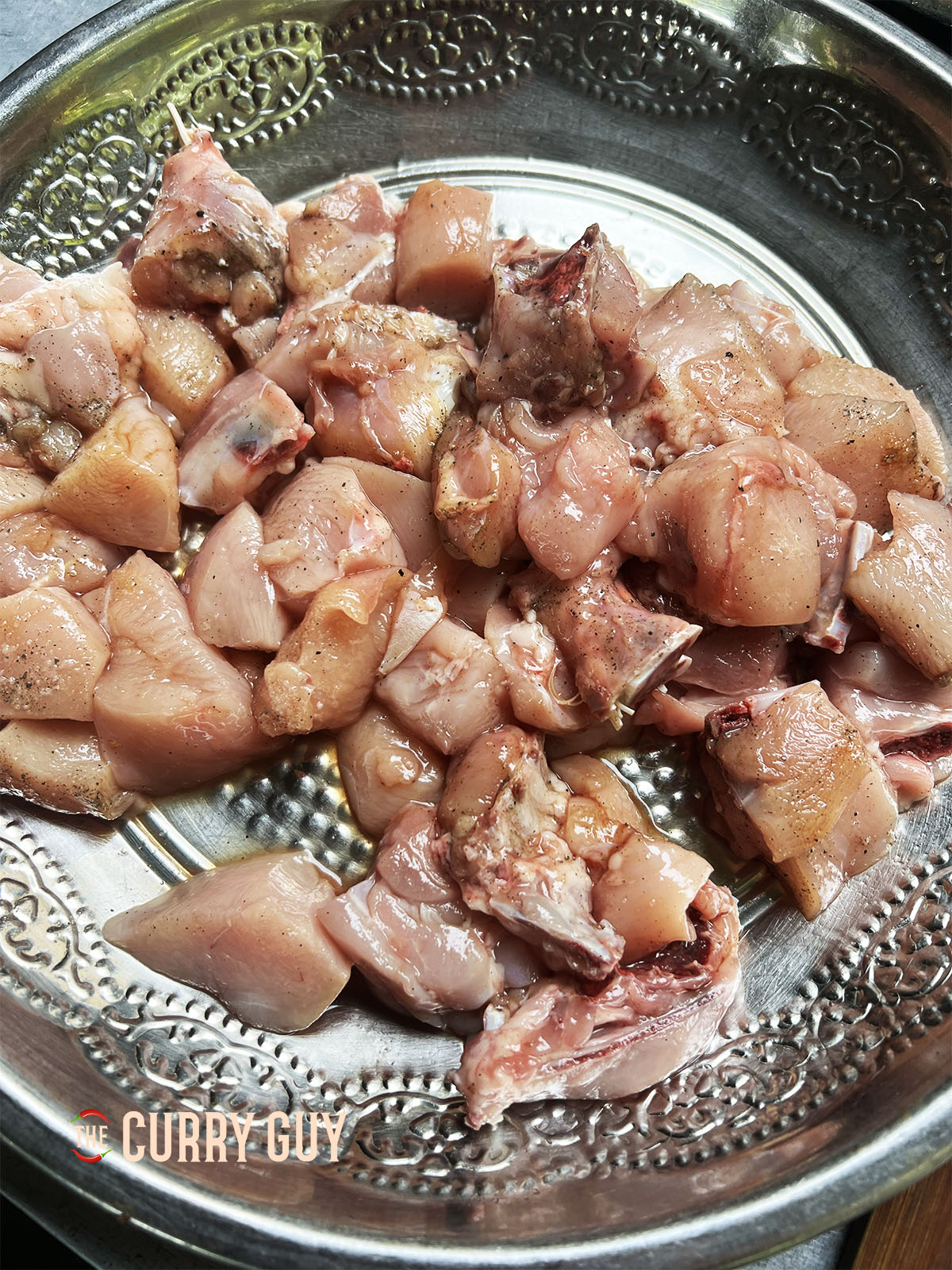 The chicken ready for cooking, coated with salt, pepper and soy sauce.
