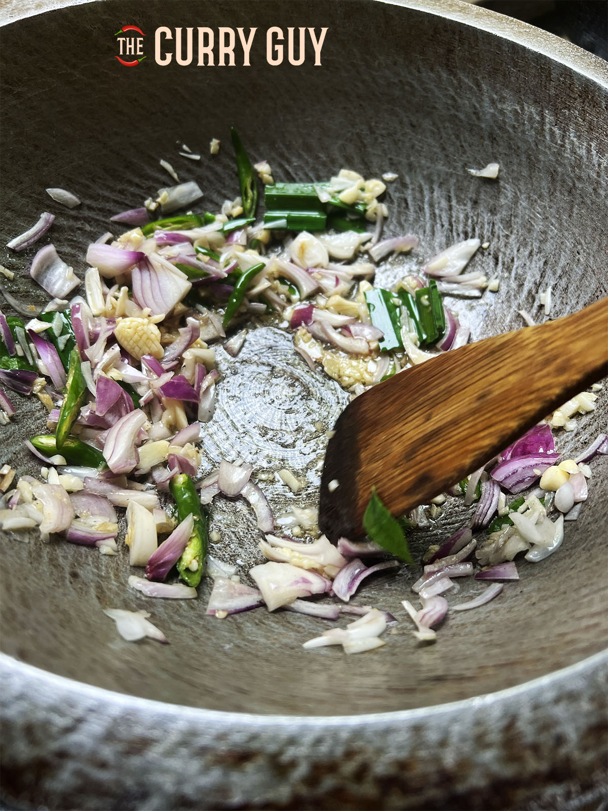Frying the spices and aromatic vegetables in the pan.