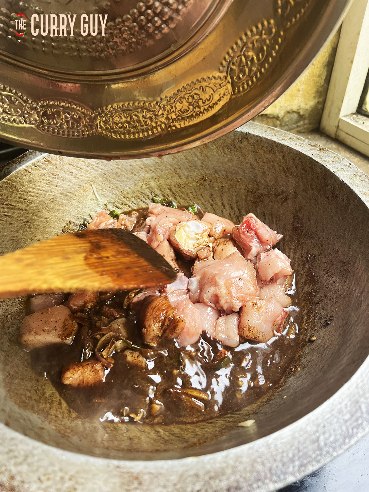 Adding the chicken to the pan.