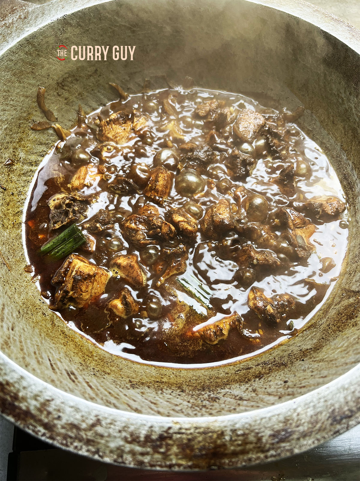 Continuing to simmer the chicken, uncovered.