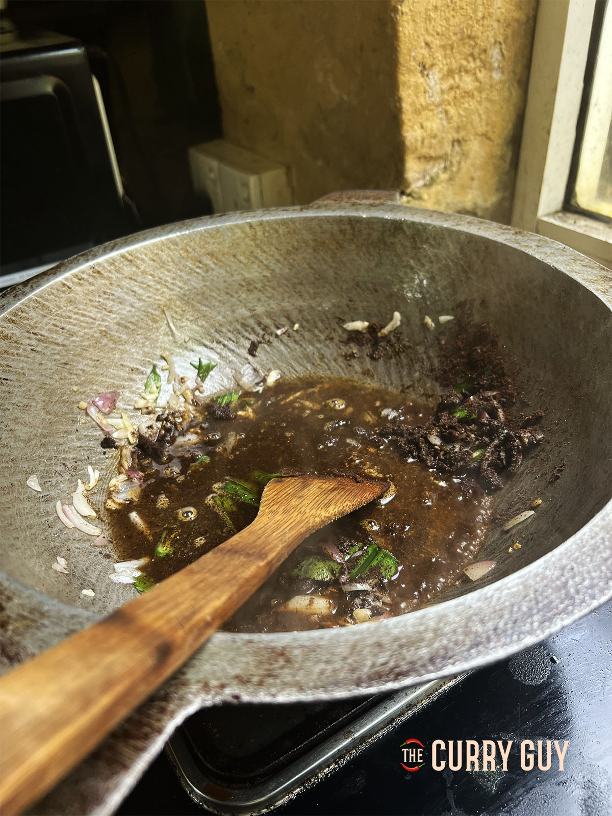 Adding water and chicken powder to the pan.