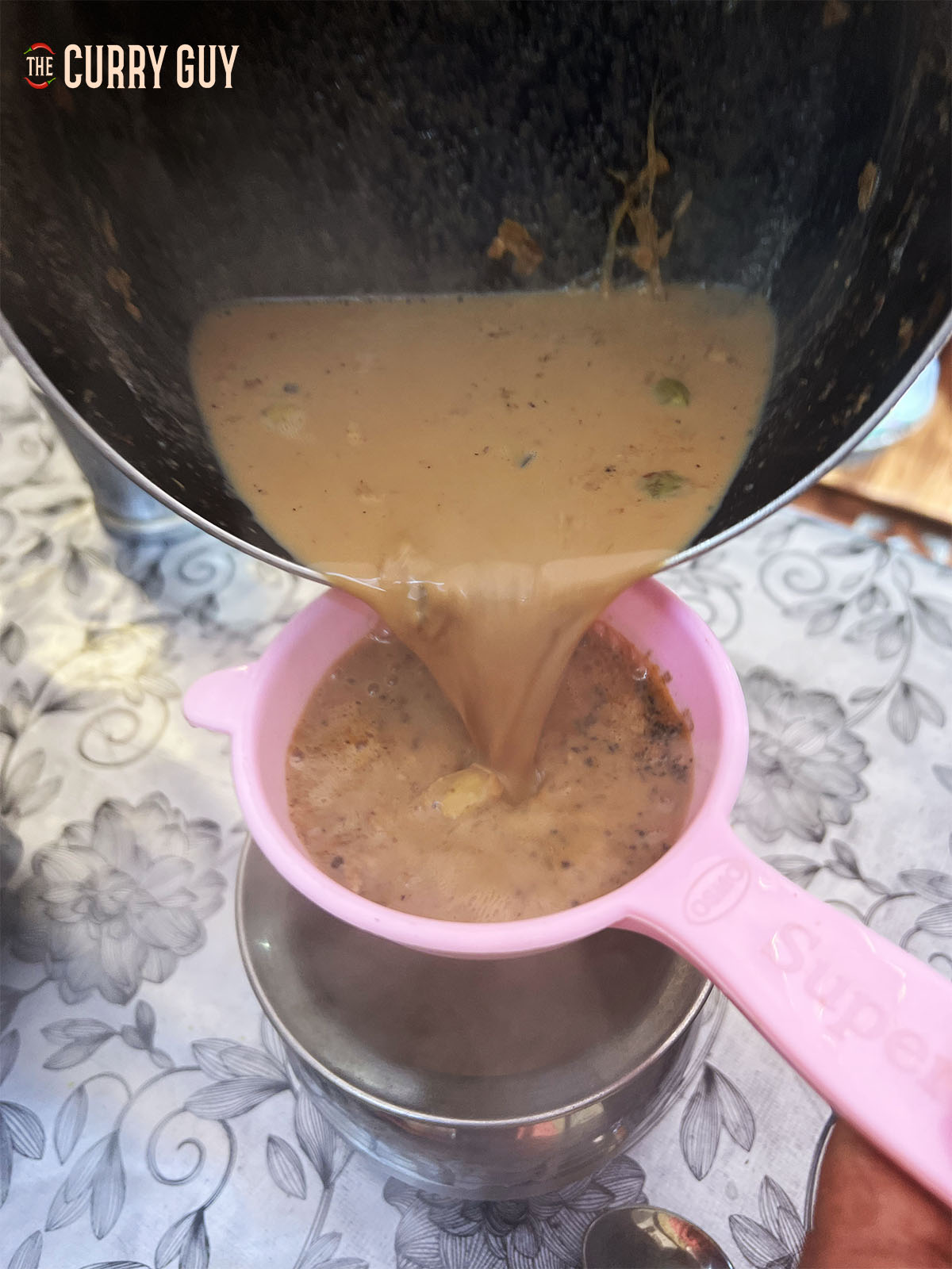 Straining the chai tea.