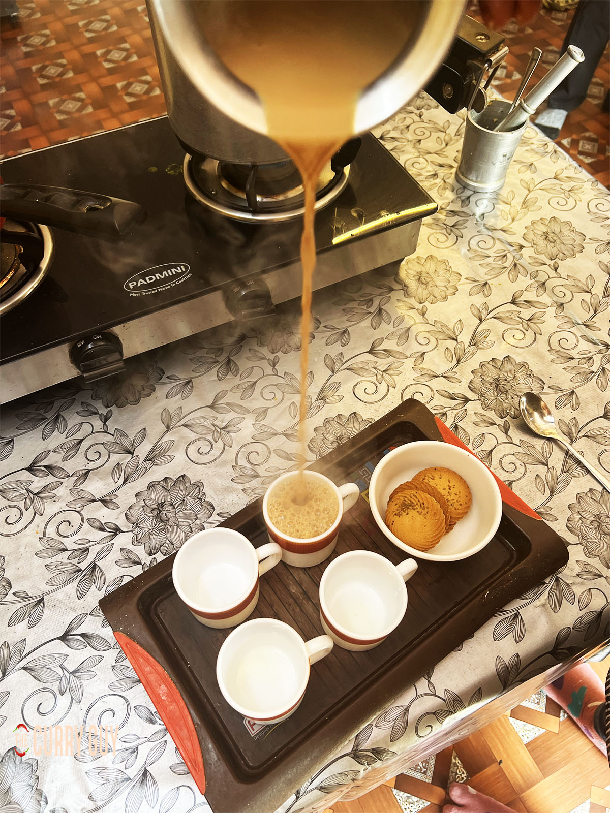 Pouring the chai tea.