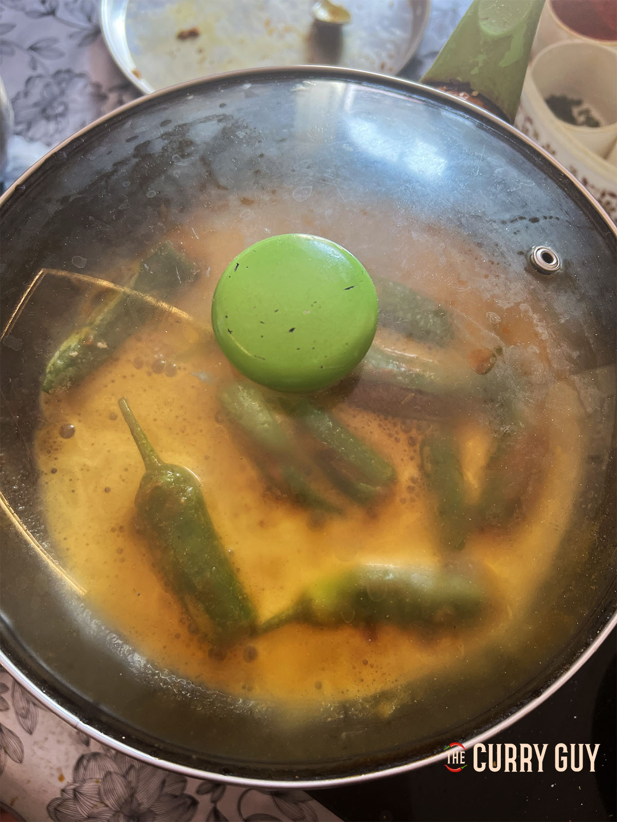 Simmering the chillies covered in a pan.