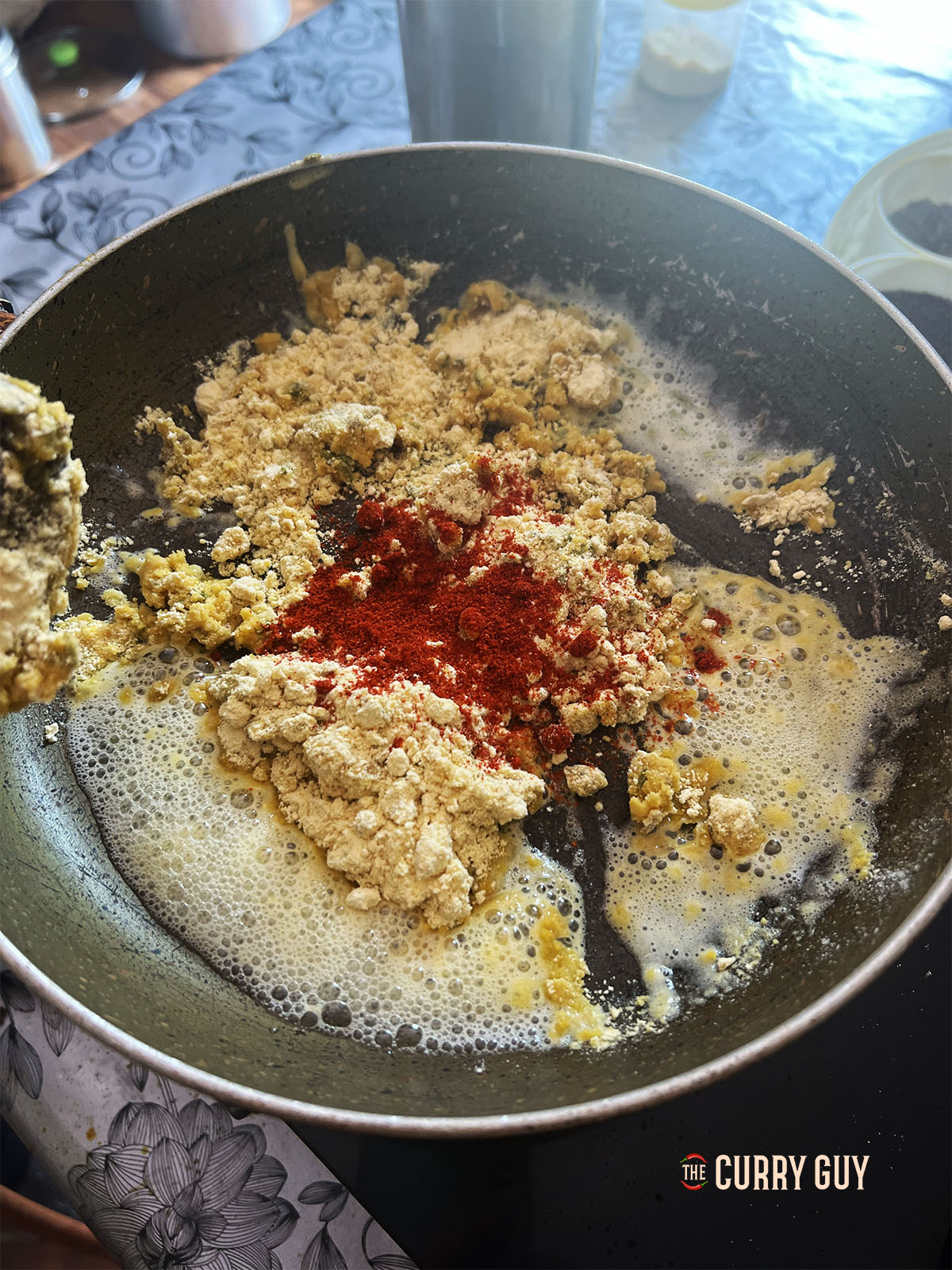 Adding the chilli powder, salt, ground turmeric, ground coriander and mango powder to the pan.
