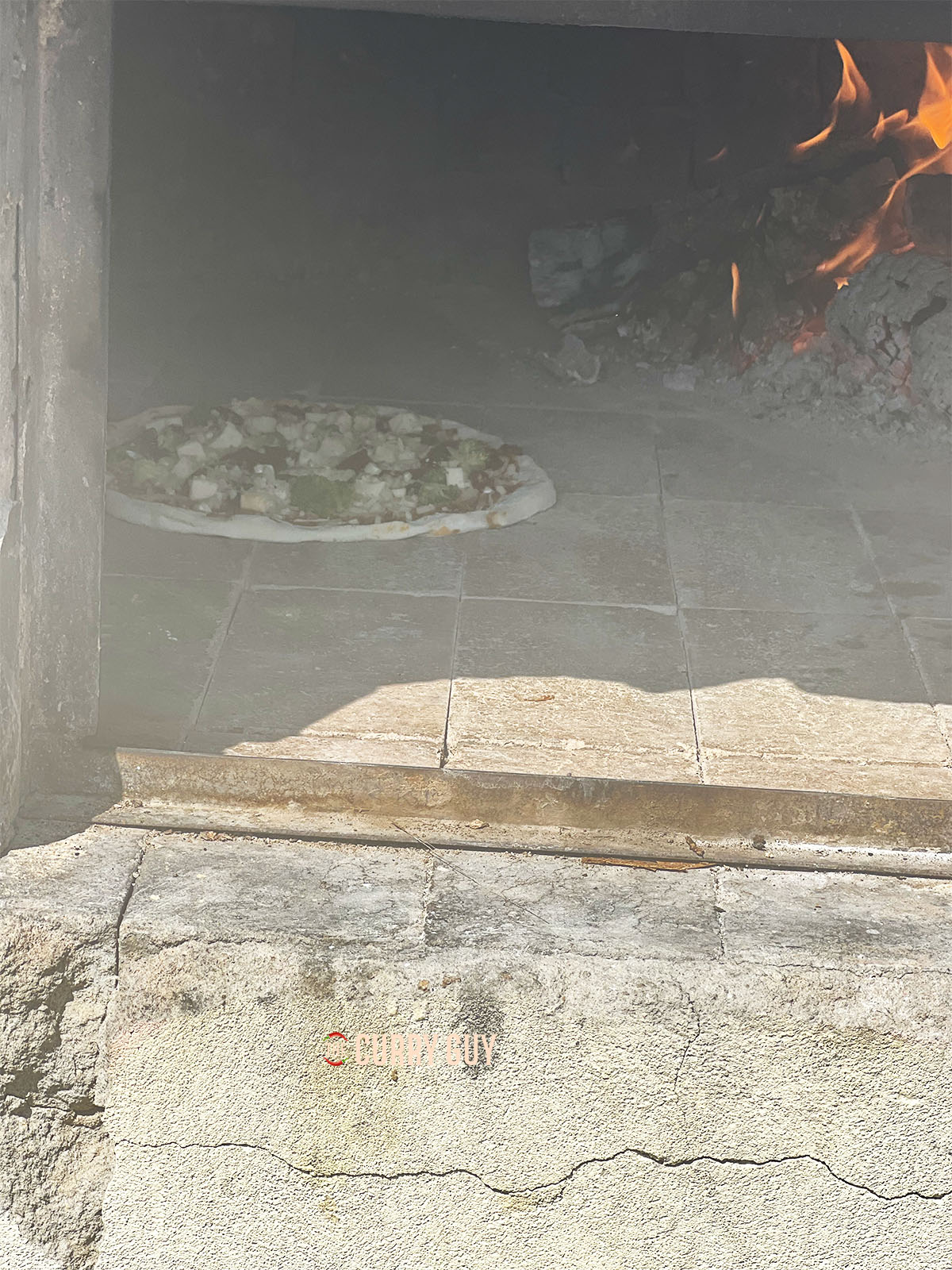 Oven cooking in a pizza oven.