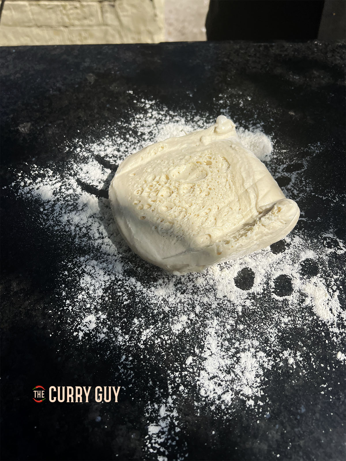 Placing the dough on a floured surface.