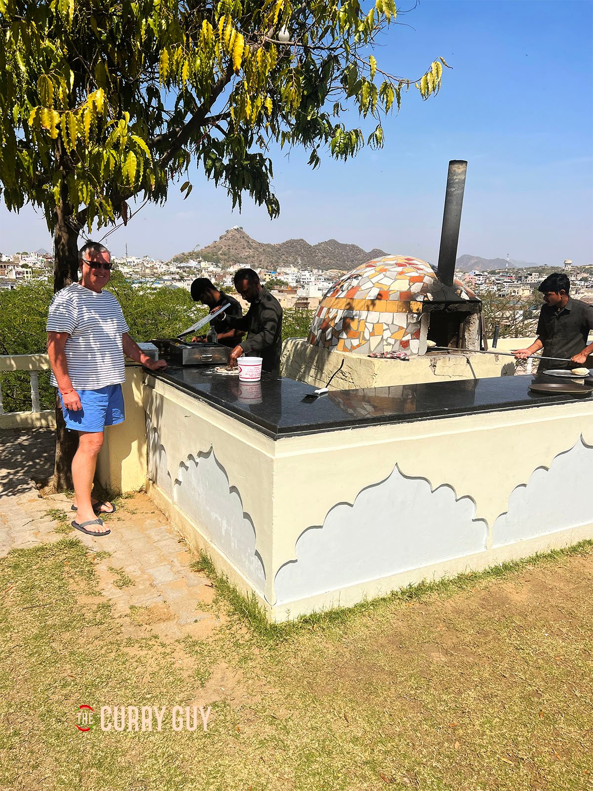 The Curry Guy, Dan Toombs by a pizza oven.