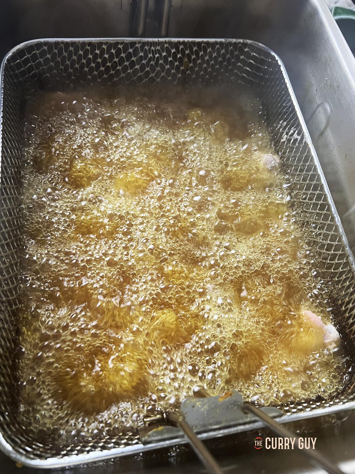 Deep frying the chicken wings.