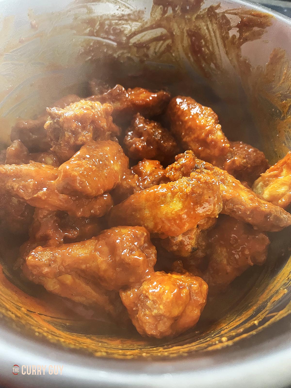 Stirring the sauce and chicken together.