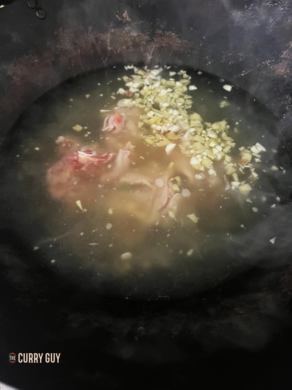 Cooking the chicken in the simmering stock.