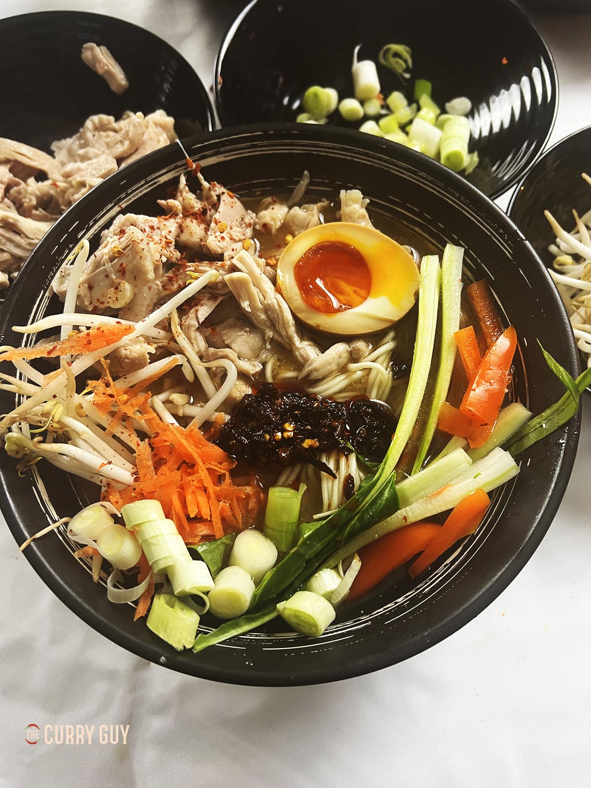 Adding different ingredients to the bowls.