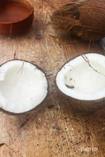 Separating the coconut halves.