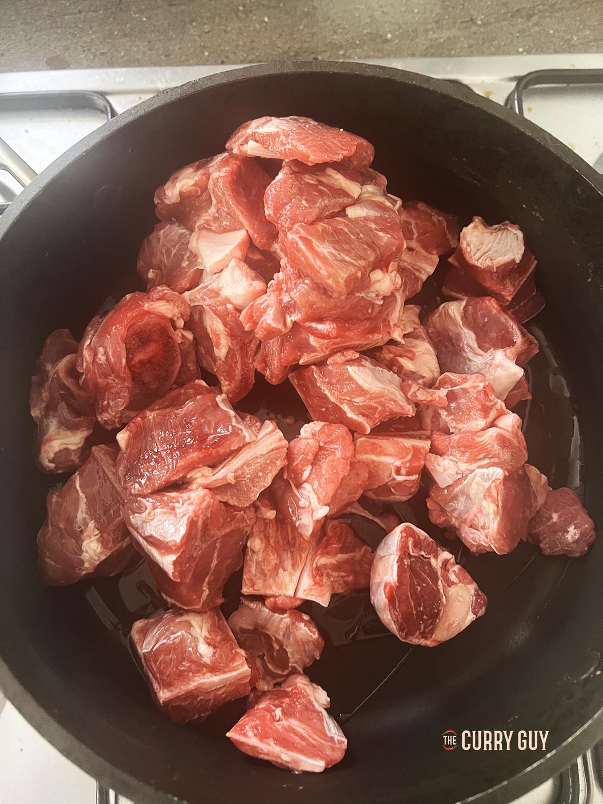 Browning the meat in a pan.