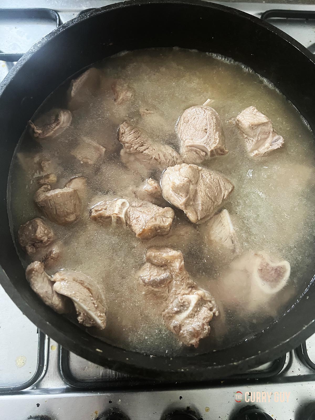 Simmering the meat to tenderise it. 