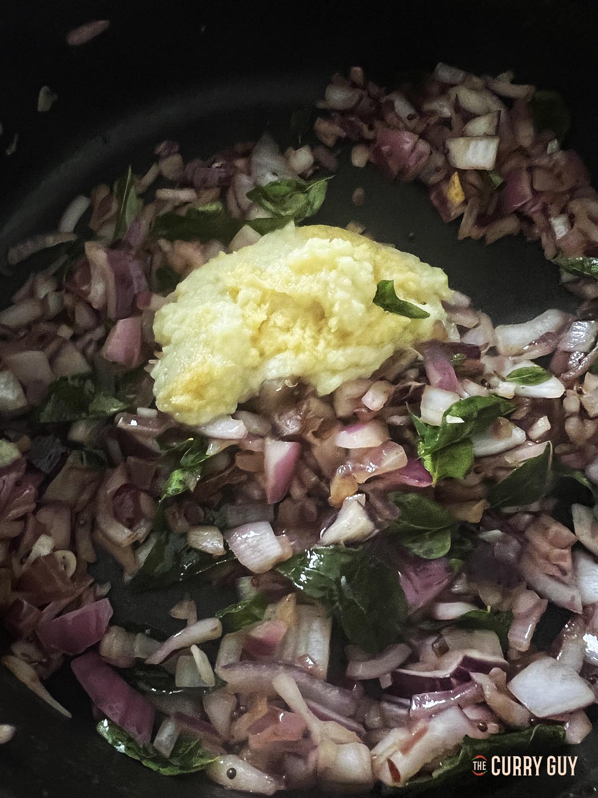 Adding the garlic and ginger paste to the pan.