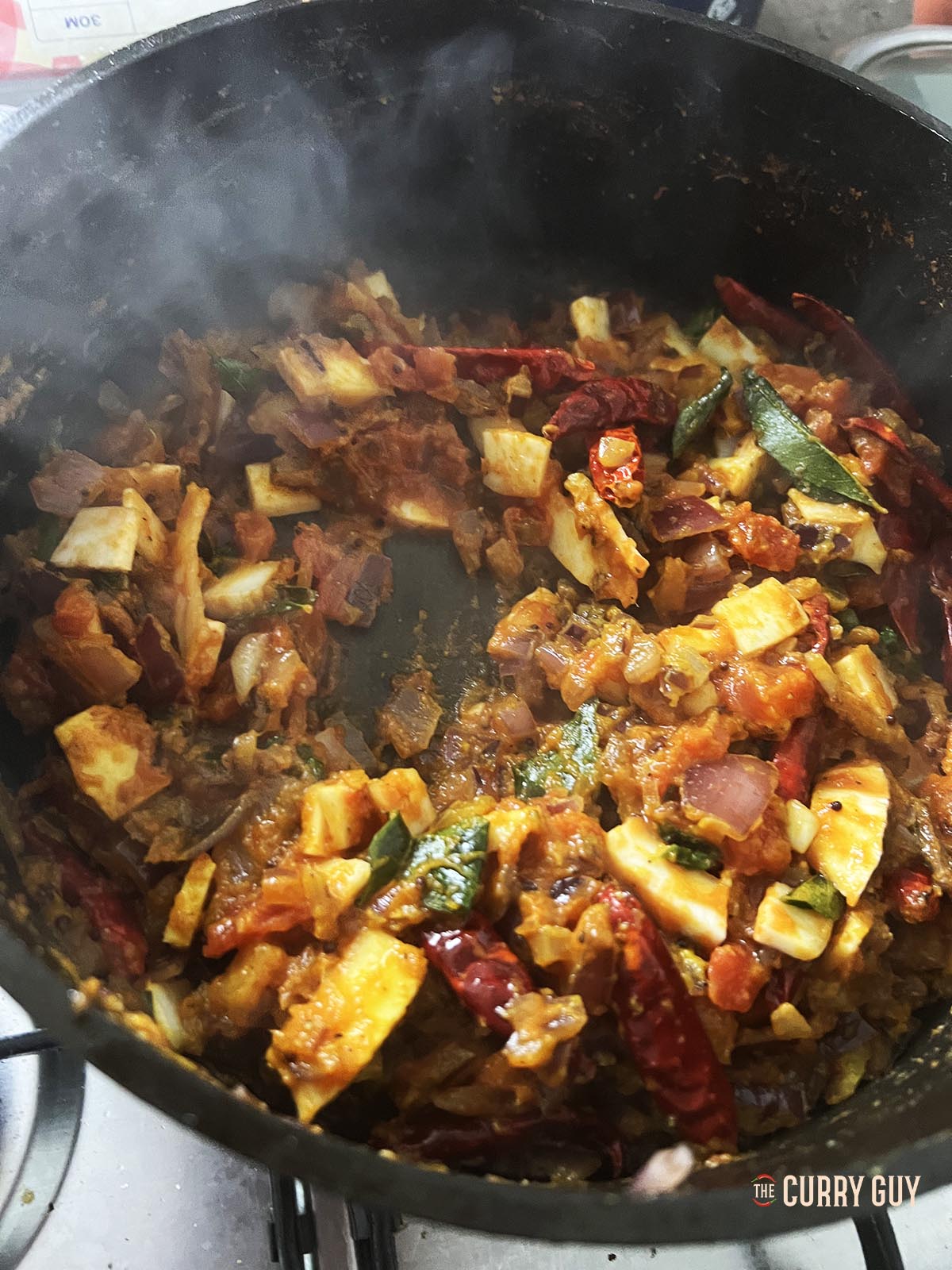 Simmering the sauce to thicken it.