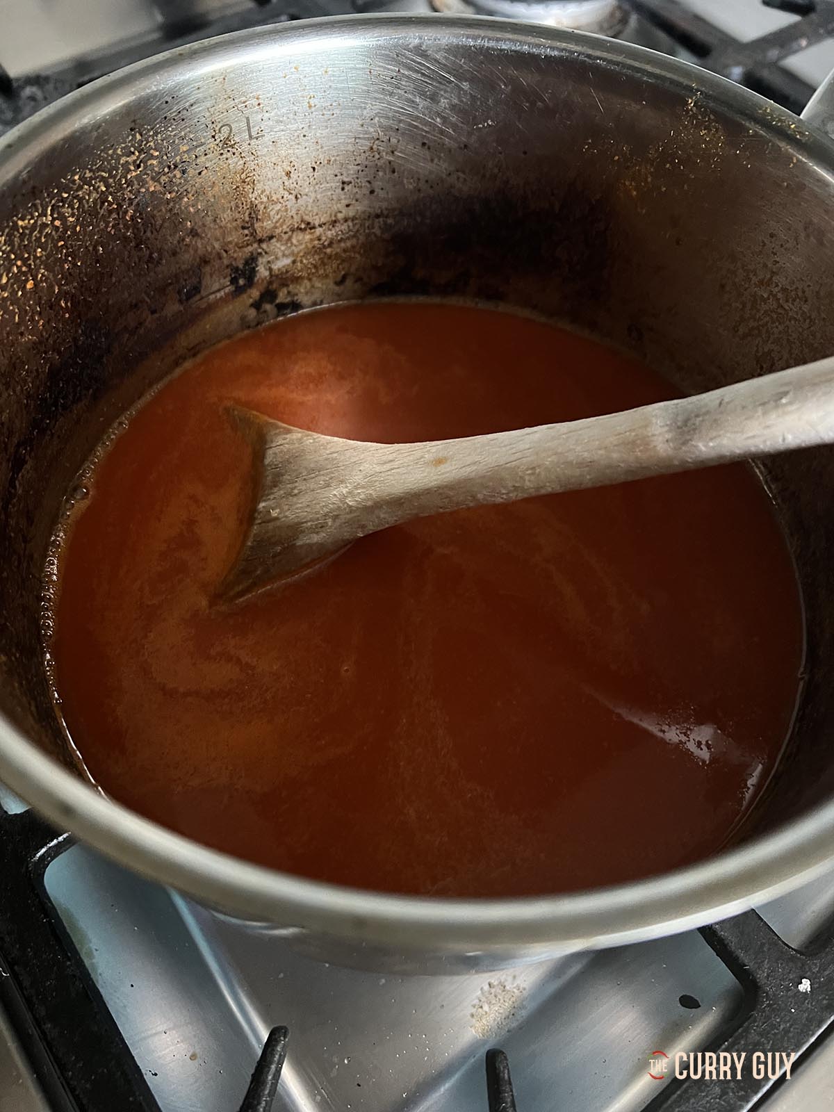 Simmering the sriracha sauce in a pan.