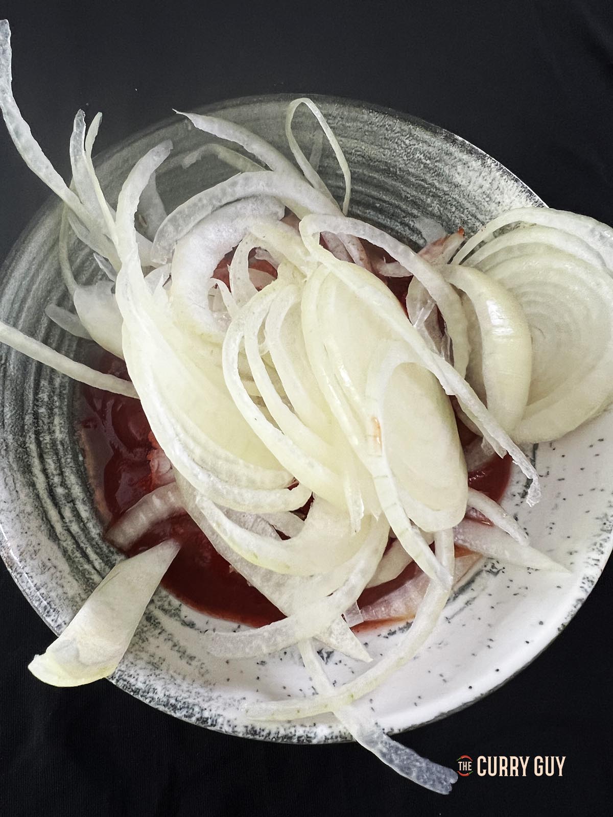 Adding onions to the chutney dressing