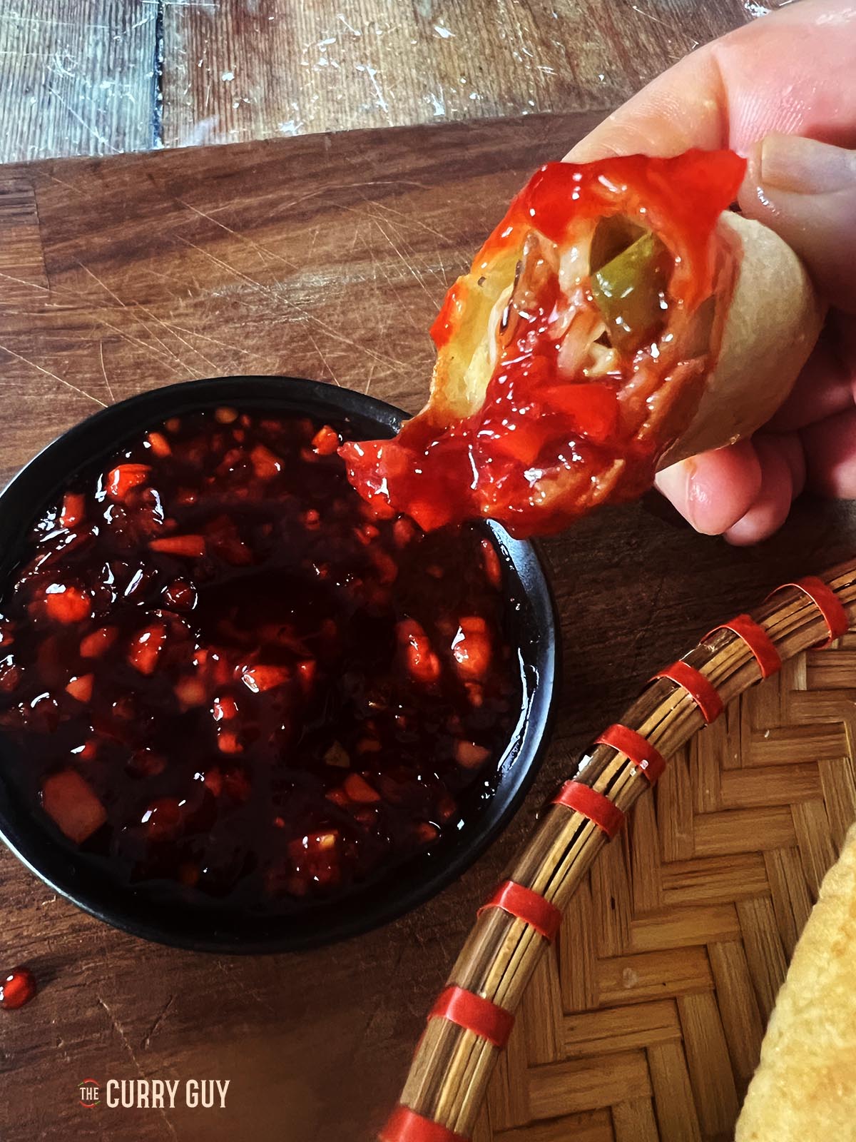 Vegetable spring roll dipped in homemade sweet and sour sauce.