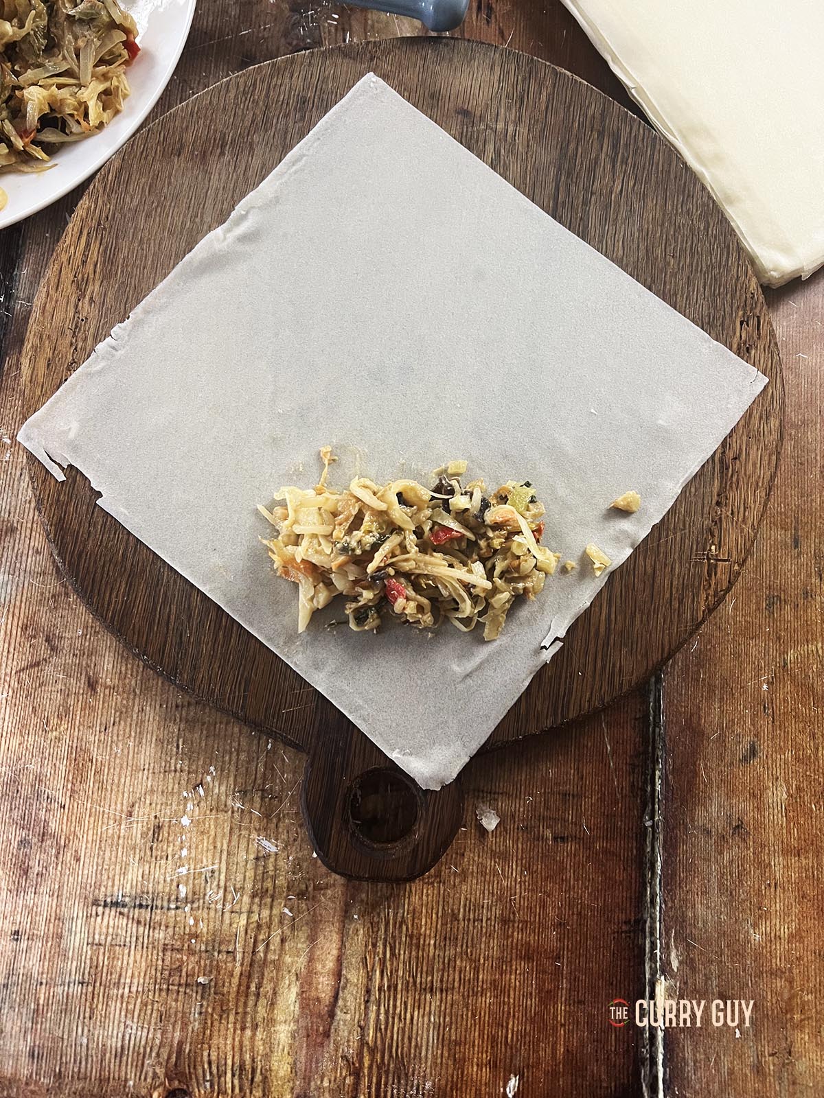 Placing the filling on top of a spring roll wrapper.