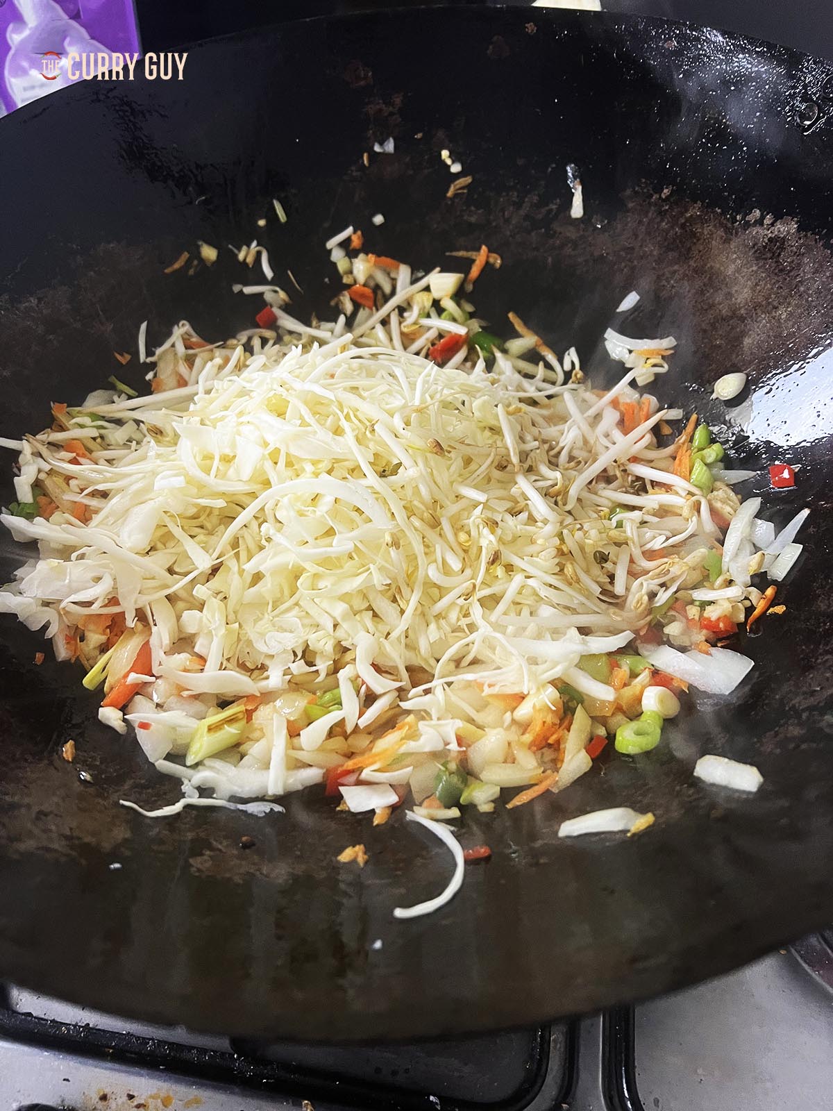 Adding the beansprouts and shredded cabbage.