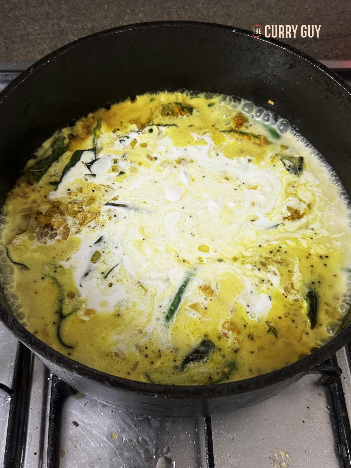 Adding the coconut milk to the pan.