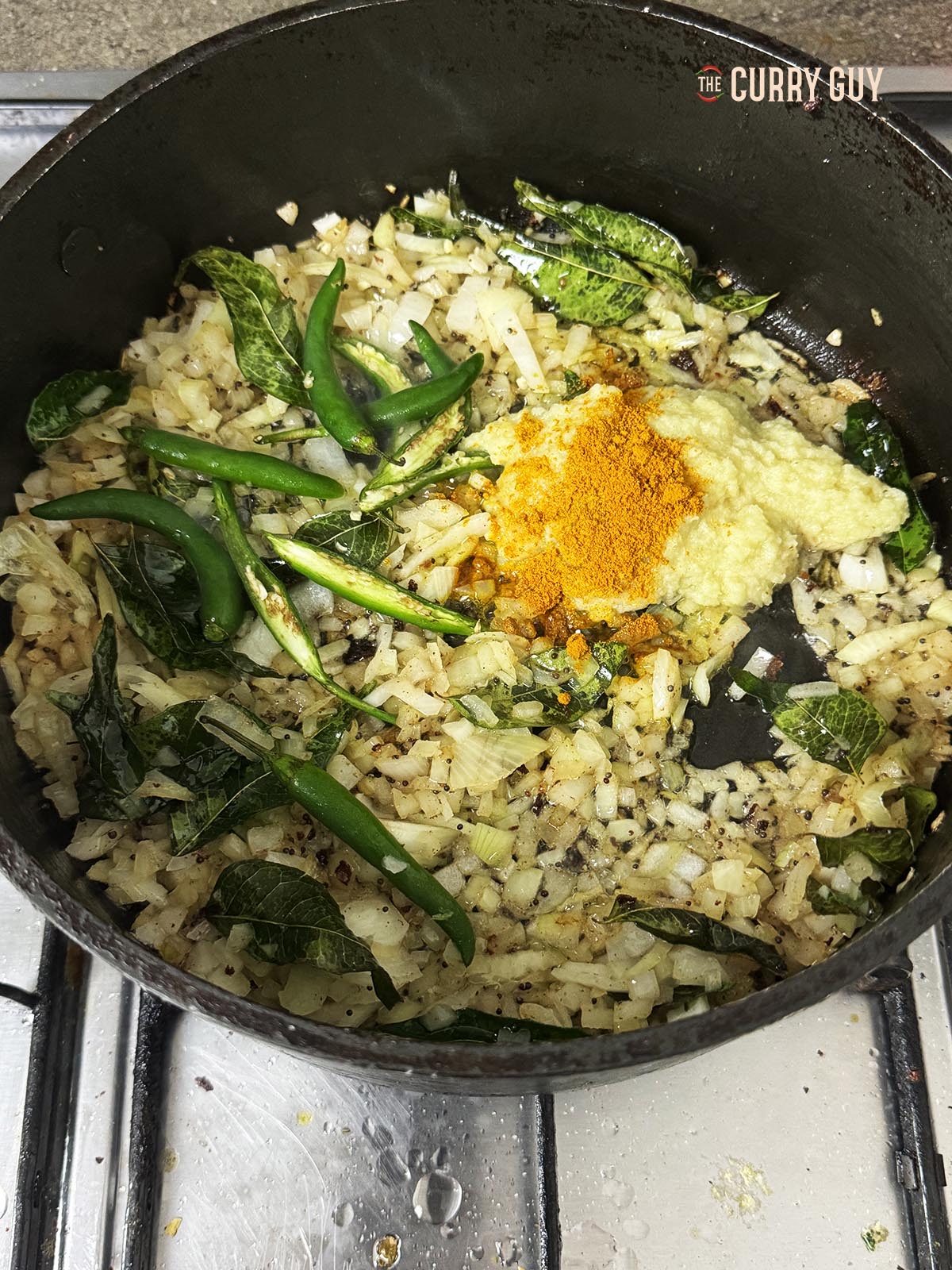 Adding the garlic and ginger paste and the ground turmeric.