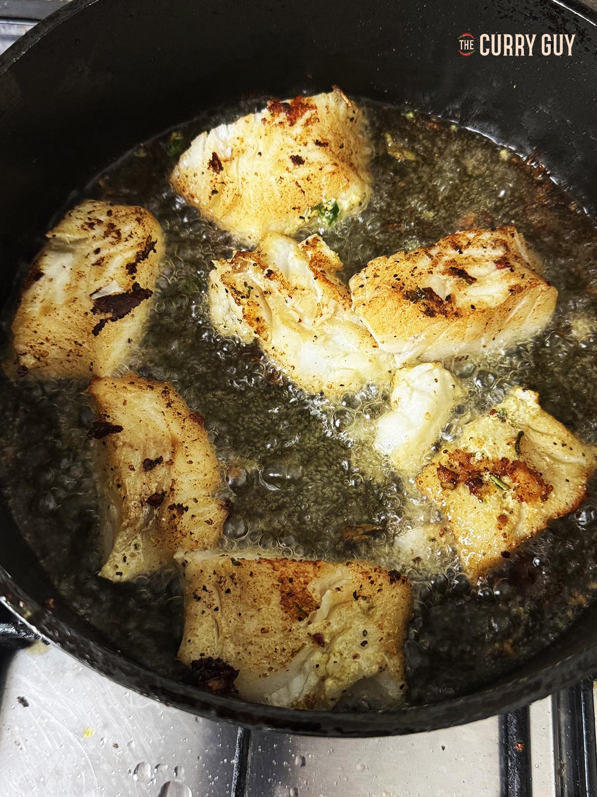 Frying the marinated fish.