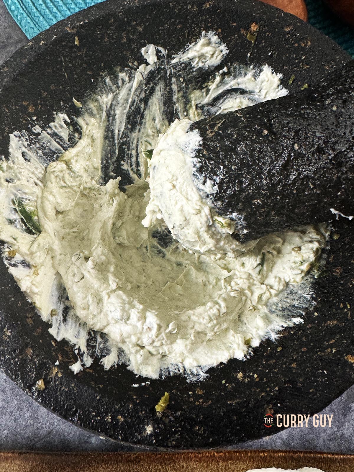 Preparing the marinade in a pestle and mortar.