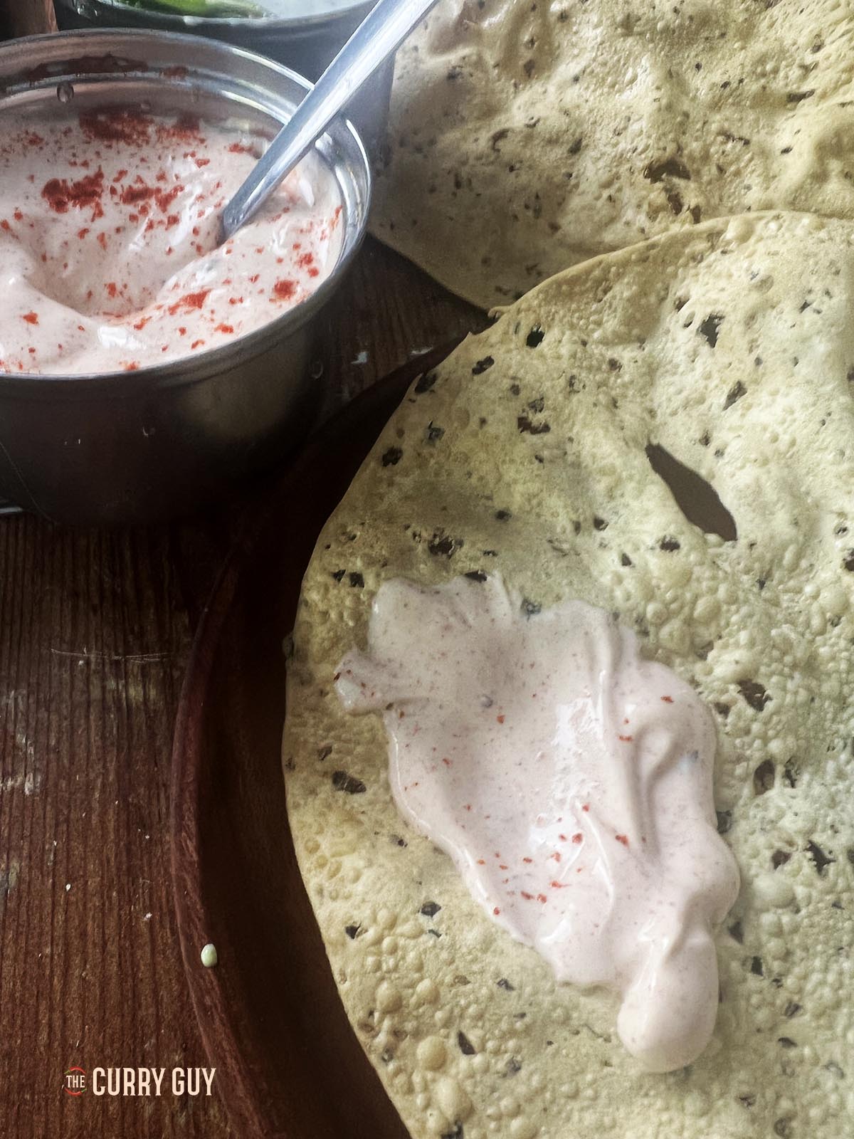 Yoghurt sauce on a poppadom.