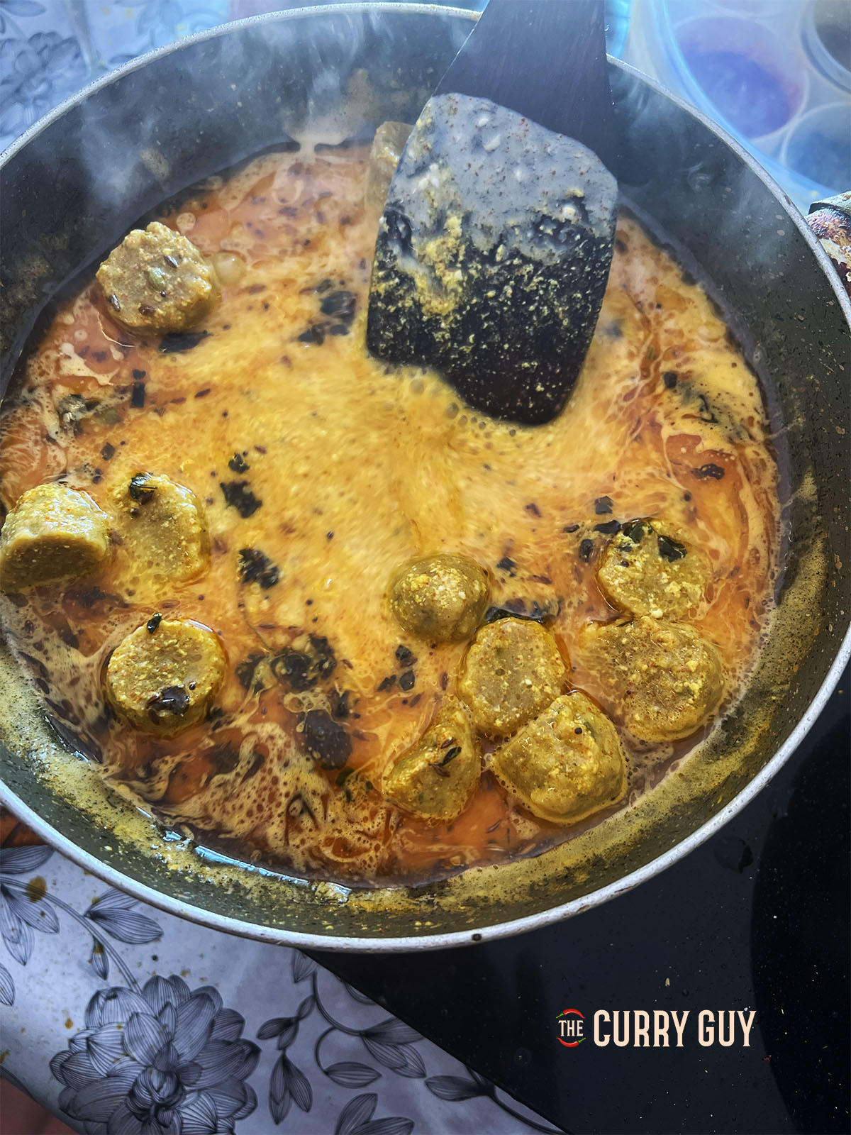 Seasoning the gatte ki sabji and adding coriander (cilantro) and chillies to serve.