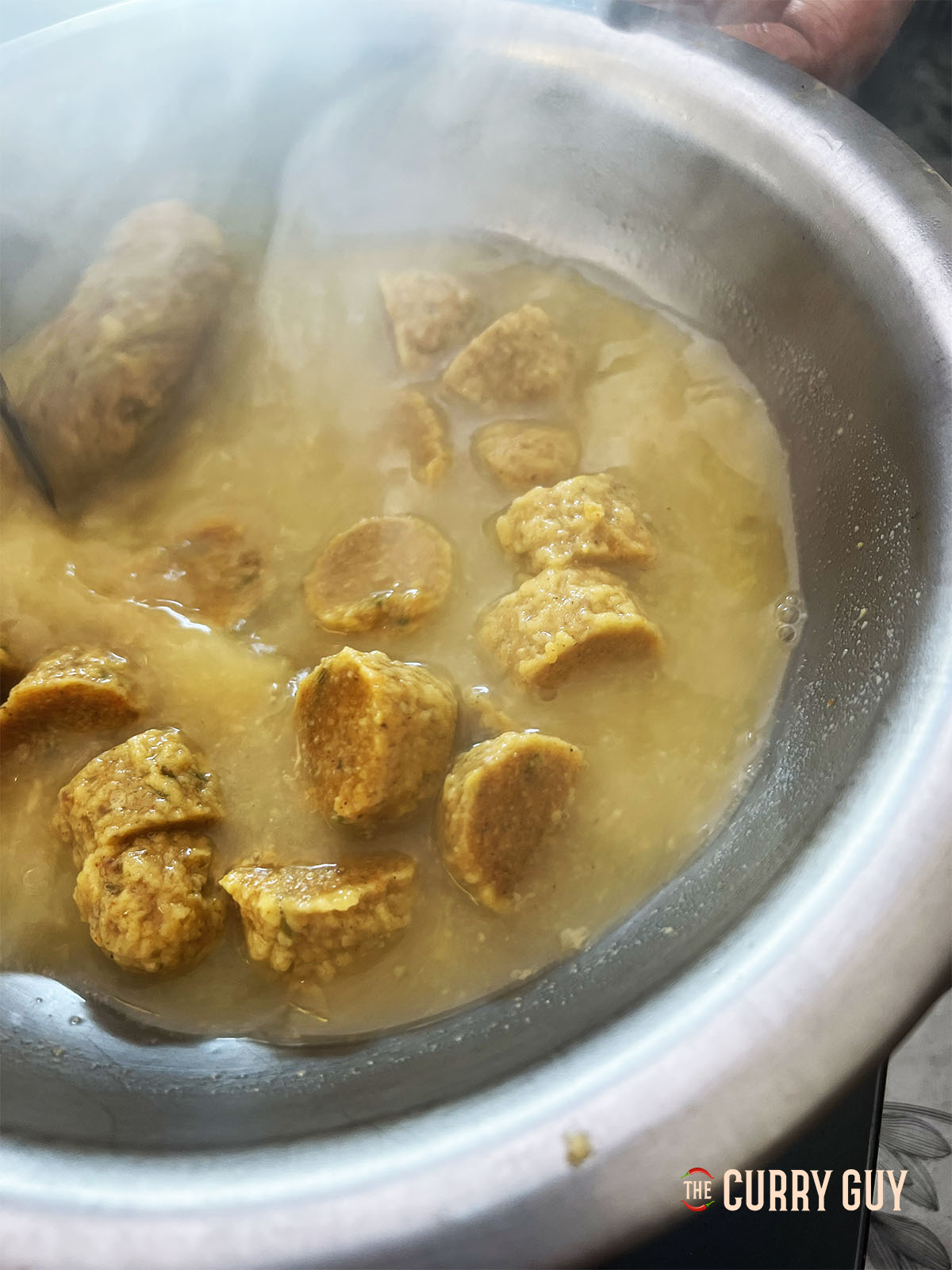 Slicing the gram flour dumplings into bite sized pieces.