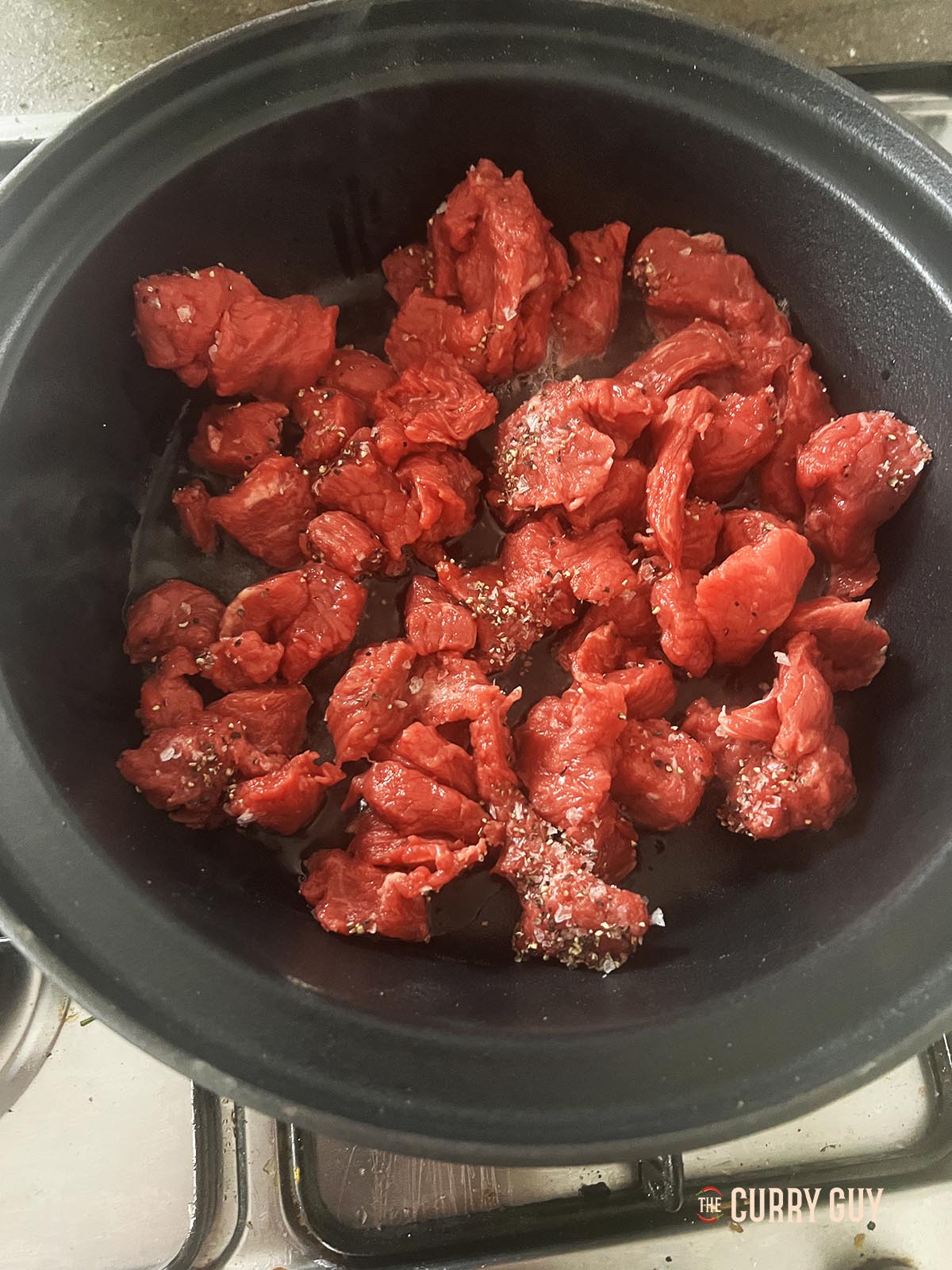 Frying the meat in batches.