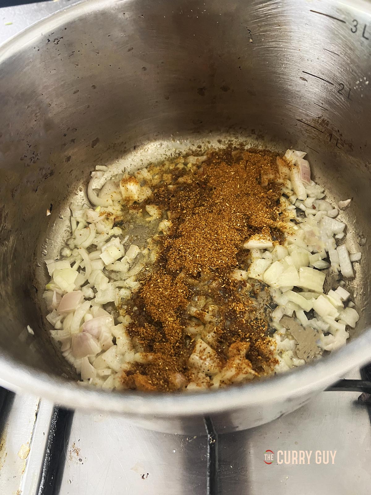 Frying the shallots and adding the ras el hanout.