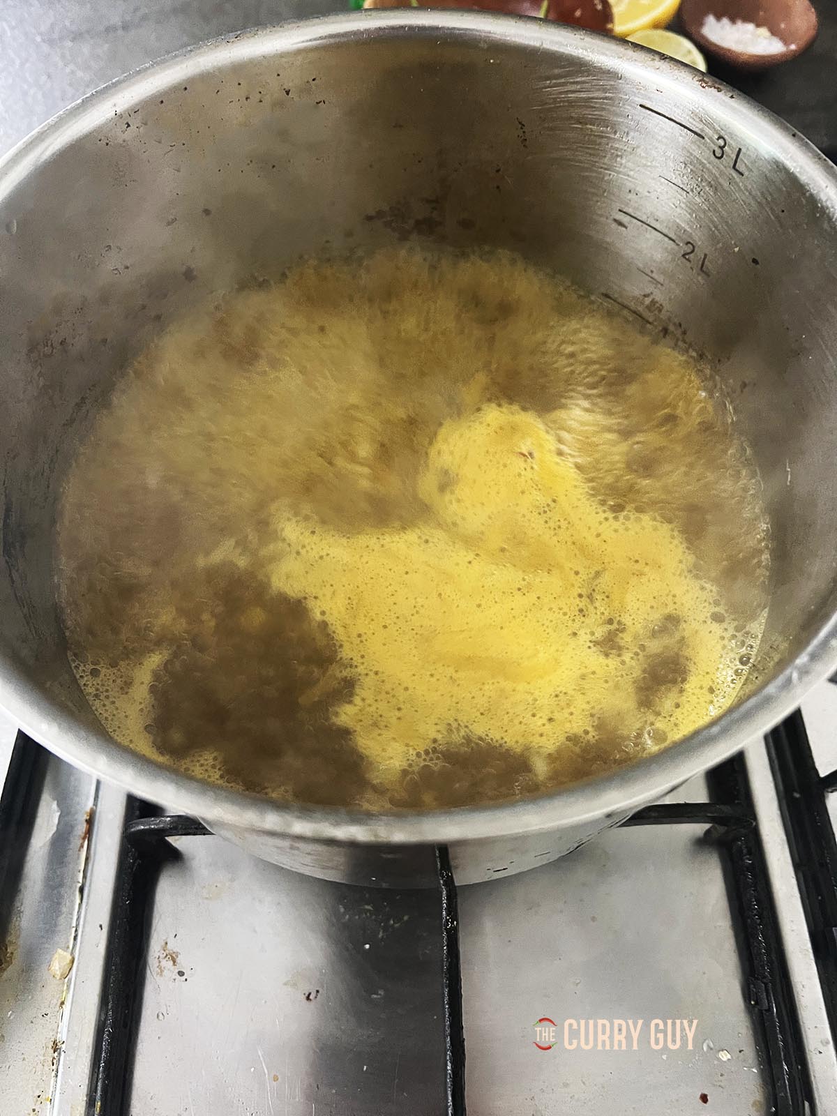 Adding chicken stock and bringing it to a boil.