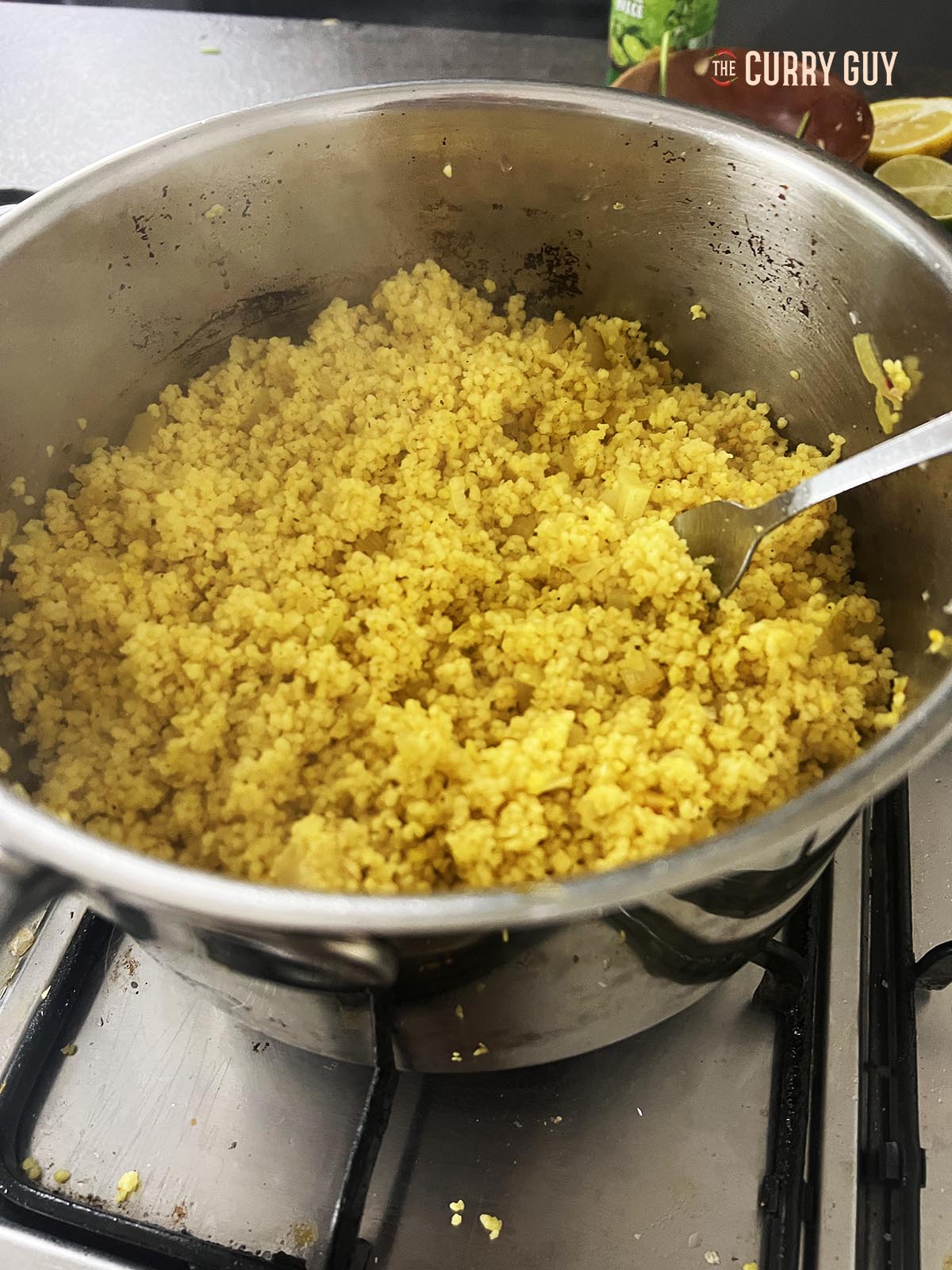 Fluffing up the couscous with a fork.