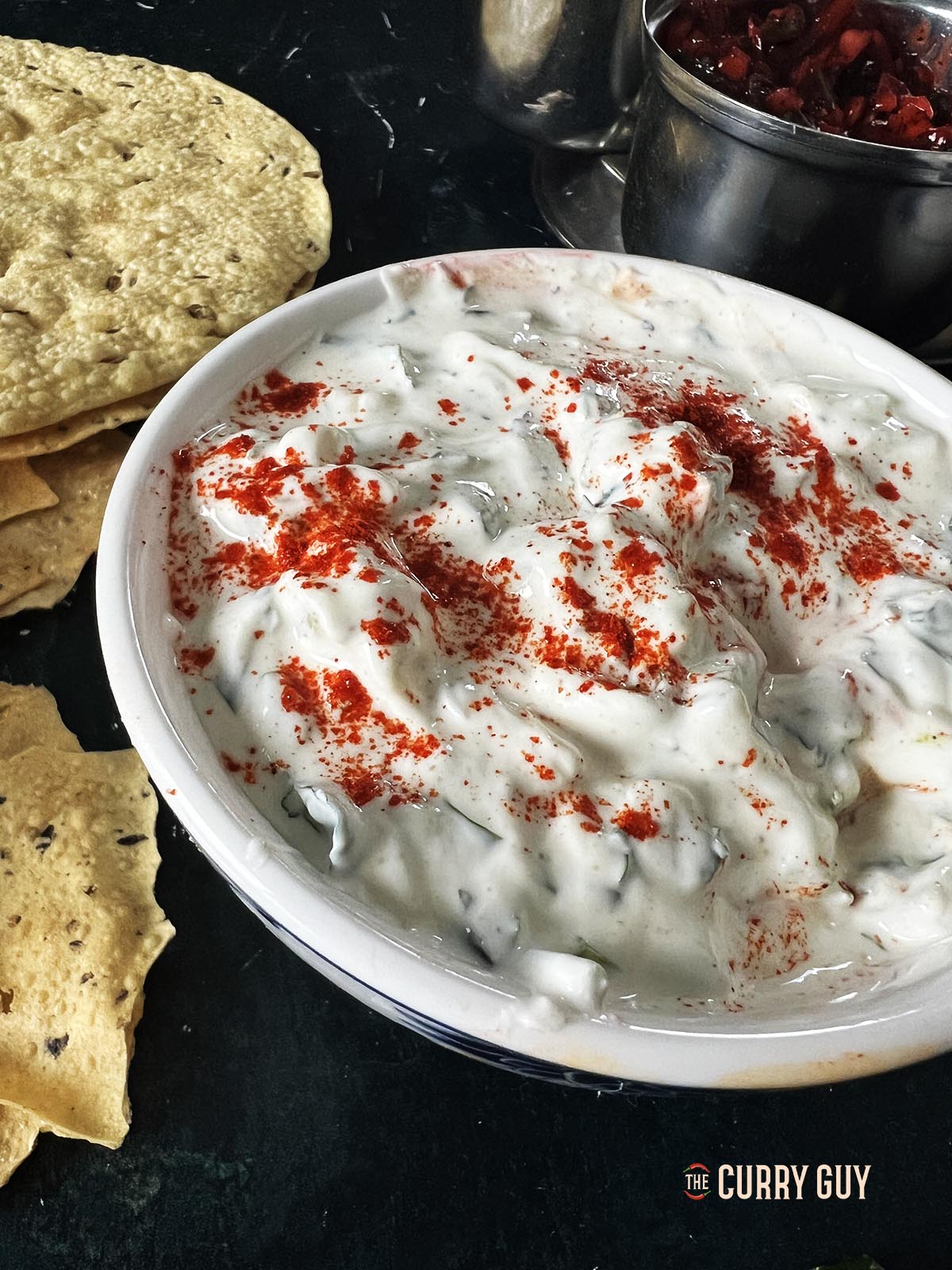 Cucumber raita in a serving bowl.