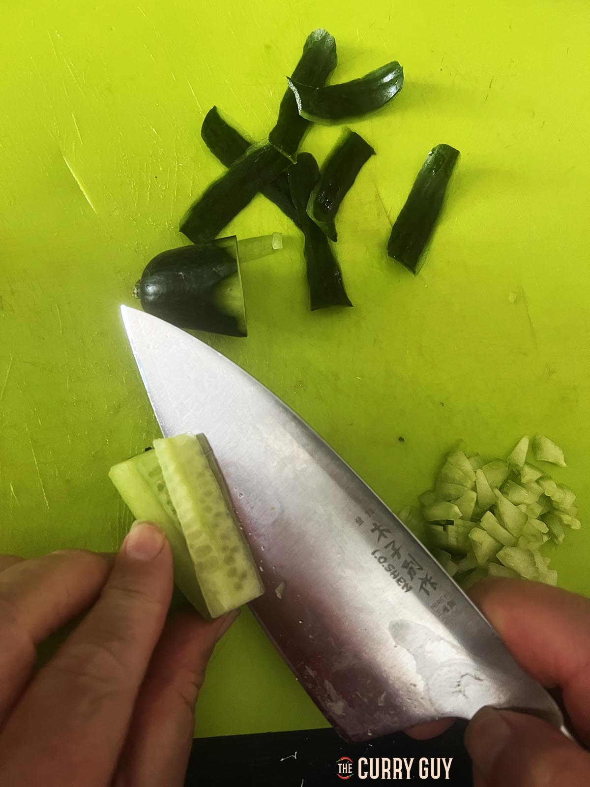 Cutting the seeds out of the cucumber.