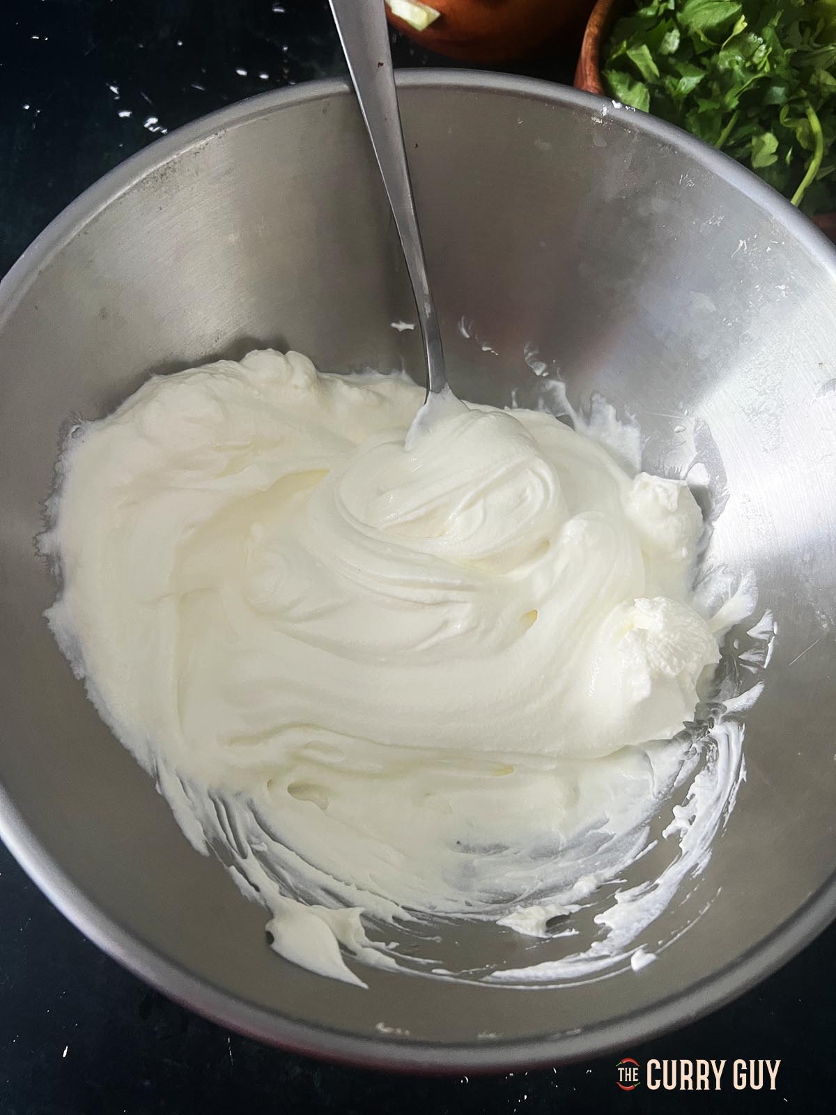 Whisking the yoghurt.