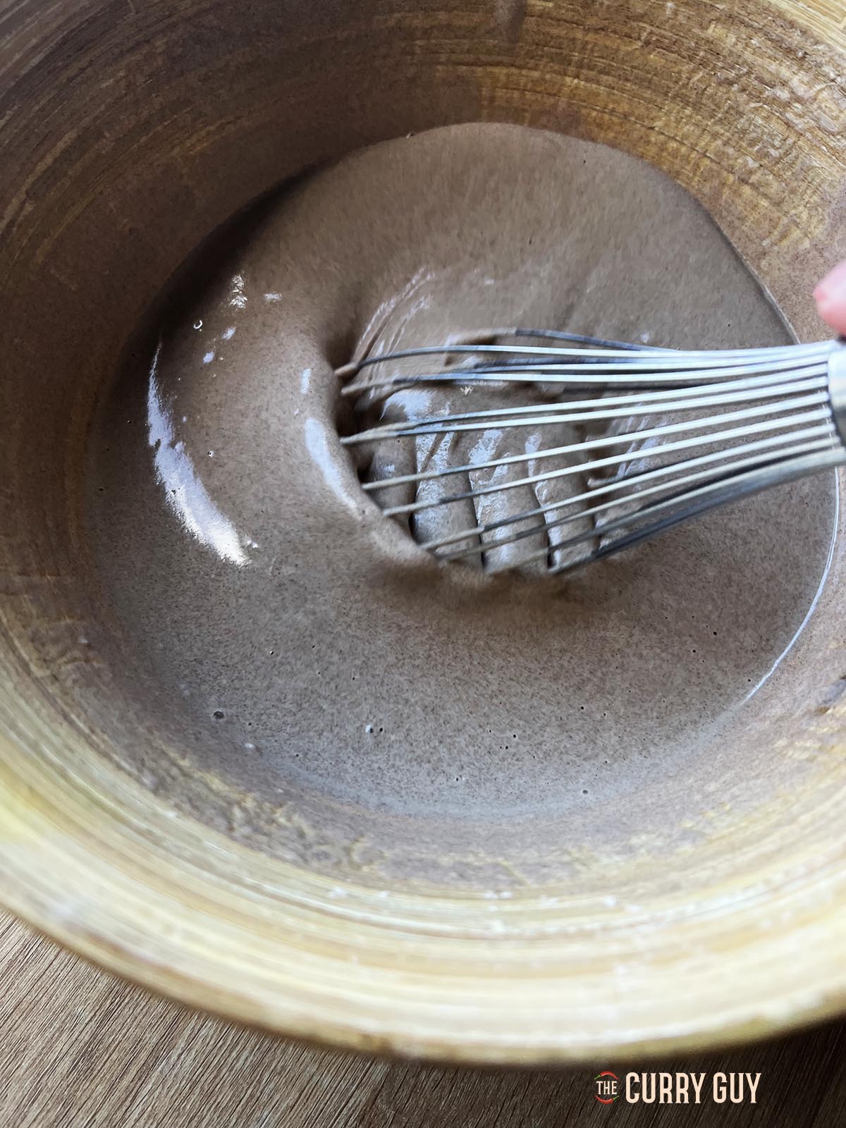 Whisking the batter so that it is smooth.
